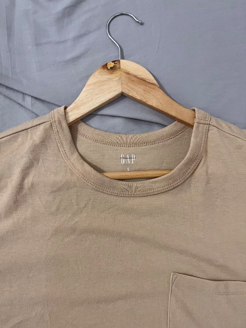 GAP Pocket T-Shirt Beige Size S (Category: Shirts) located in Muntinlupa City. Submitted by keenlion_22f510 (Listing ID 1470988964, Image 1). Description: - Brand: GAP - Color: Solid Beige - Size: Small (tag printed inside collar) - Material: Soft cotton fabric - Fit: Standard fit - Details: Classic crew neck with ribbed trim and single chest pocket - Condition: Great basic for casual wear.