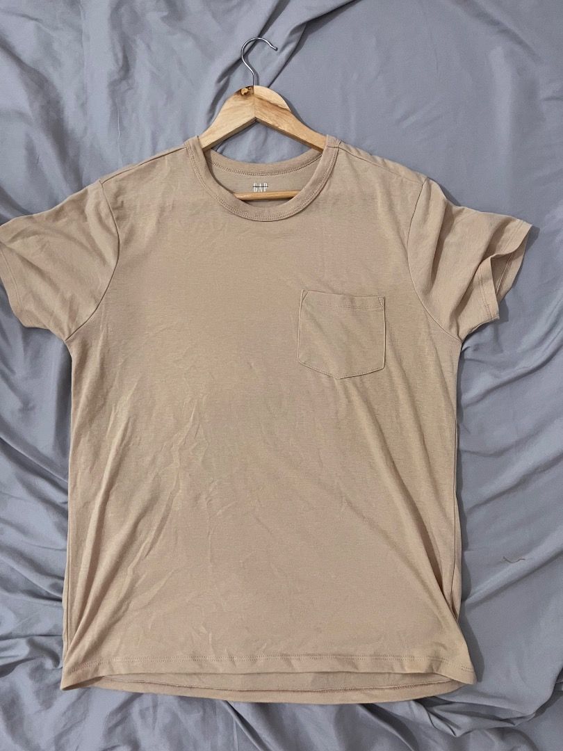 GAP Pocket T-Shirt Beige Size S (Category: Shirts) located in Muntinlupa City. Submitted by keenlion_22f510 (Listing ID 1470988964, Image 2). Description: - Brand: GAP - Color: Solid Beige - Size: Small (tag printed inside collar) - Material: Soft cotton fabric - Fit: Standard fit - Details: Classic crew neck with ribbed trim and single chest pocket - Condition: Great basic for casual wear.