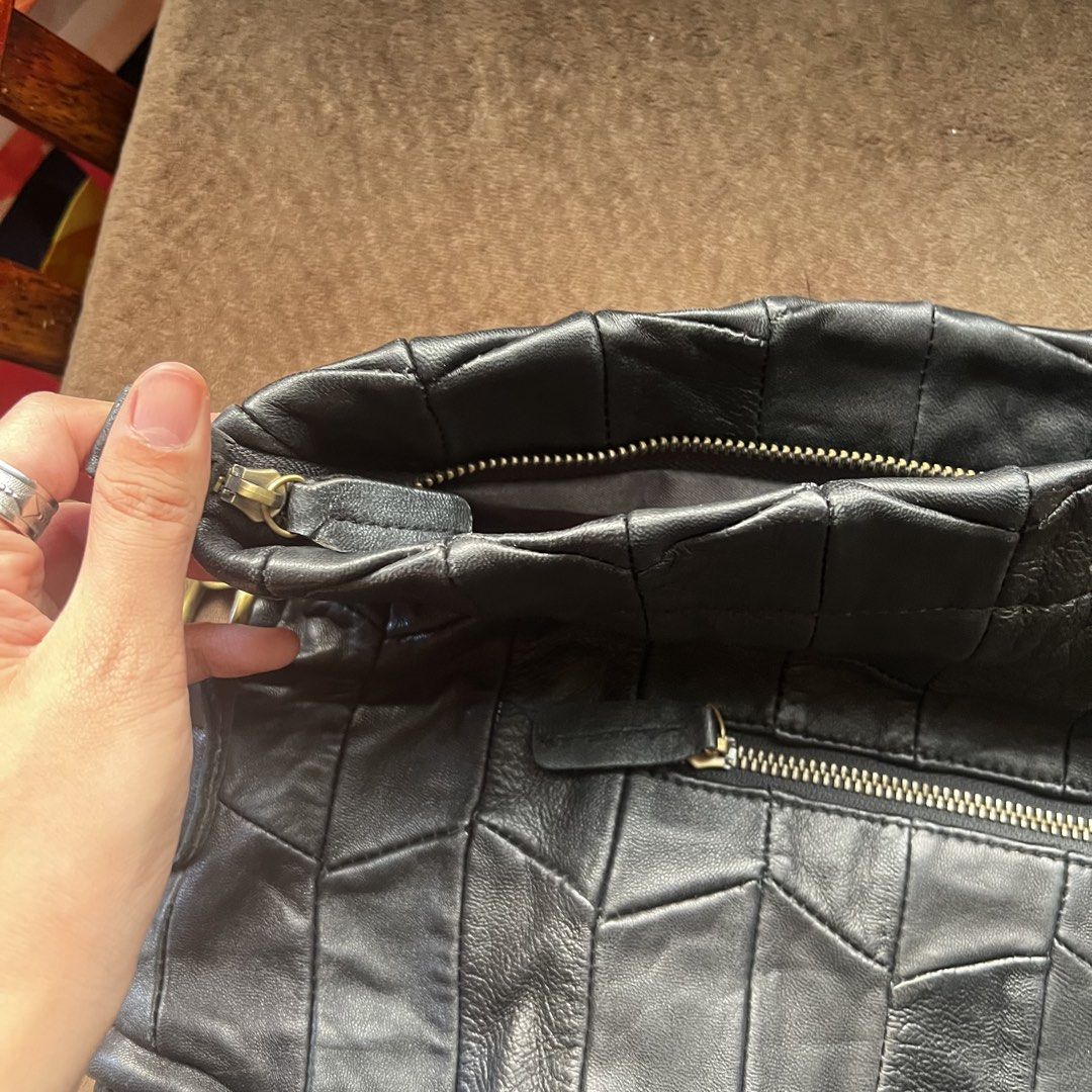 Genuine leather black slouchy dumpling fold-over bag (Category: Shoulder Bags) located in Makati City. Submitted by monu__ (Listing ID 1470977935, Image 3). Description: Perfect slouchy bag Super spacious Dumpling shaped bag when work over the shoulder Haa fold over flap with zipper for anti-theft High quality genuine leather NO issues. NO tearing or peeling of leather Still in good condition .