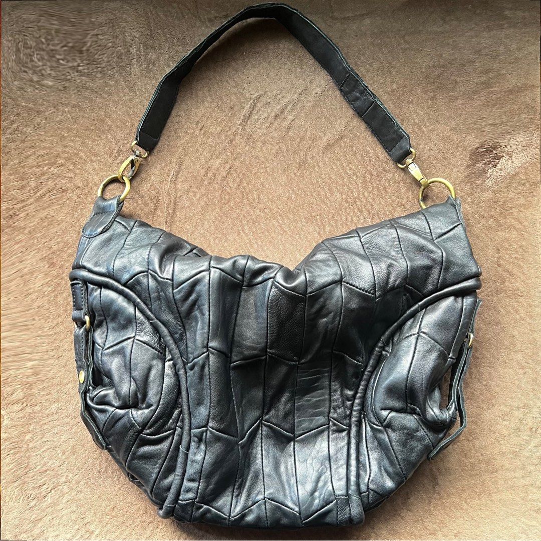 Genuine leather black slouchy dumpling fold-over bag (Category: Shoulder Bags) located in Makati City. Submitted by monu__ (Listing ID 1470977935, Image 1). Description: Perfect slouchy bag Super spacious Dumpling shaped bag when work over the shoulder Haa fold over flap with zipper for anti-theft High quality genuine leather NO issues. NO tearing or peeling of leather Still in good condition .