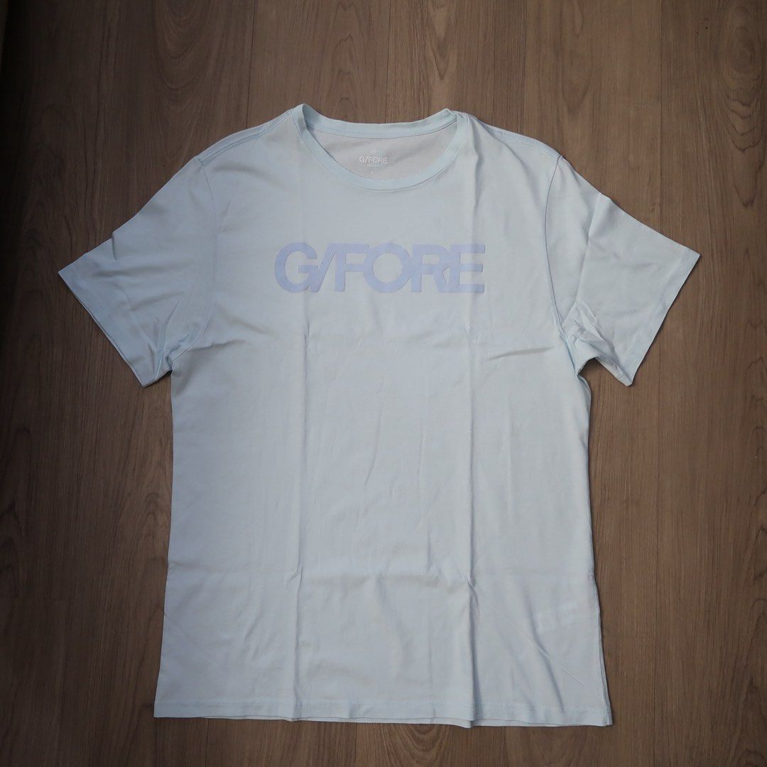 G/FORE Light Blue Logo T-Shirt Size L (Category: Tshirts & Polo Shirts ) located in Manila. Submitted by mixi_lexi (Listing ID 1471043105, Image 1). Description: - Brand: G/FORE - Color: Light Blue - Size: L (printed inside collar with brand mark) - Design: Big logo stamped across the chest - Details: Short sleeves, crew neck - Origin: Made in Peru.