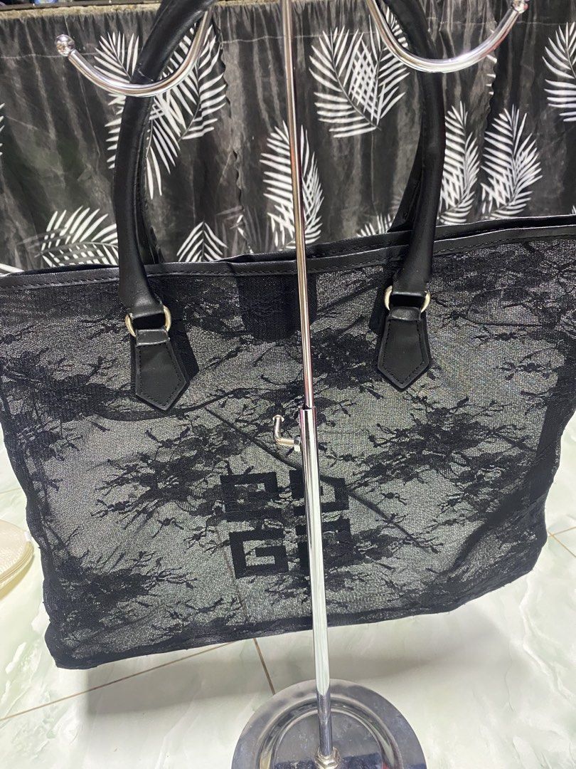 Givenchy Black Lace Tote Bag (Category: Tote Bags) located in Pasacao. Submitted by wengpullar37205 (Listing ID 1471063715, Image 3). Description: - Brand: Givenchy - Style: Tote bag / Everyday carryall - Material: Sheer lace fabric with floral pattern overlay and leather handles - Closure: Magnetic snap top closure - Interior: Very roomy, ideal for daily essentials - Condition: Good overall, with minor wear and cracking visible on the leather ha
