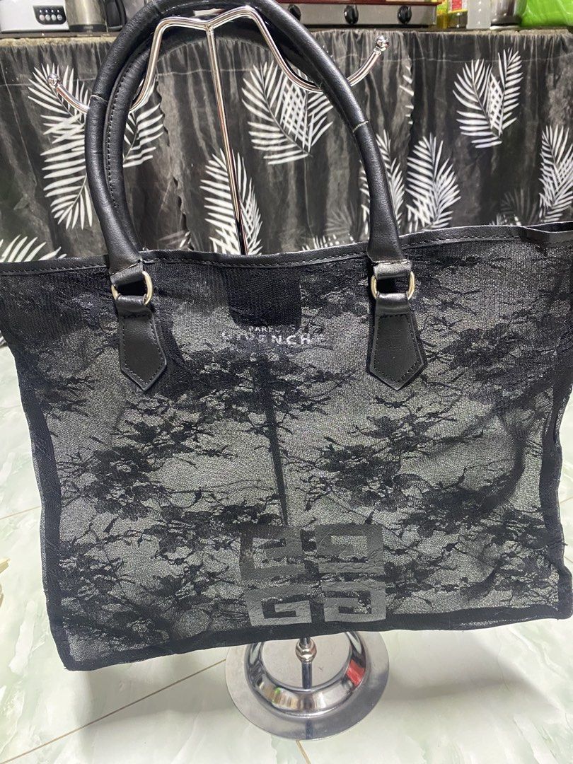 Givenchy Black Lace Tote Bag (Category: Tote Bags) located in Pasacao. Submitted by wengpullar37205 (Listing ID 1471063715, Image 1). Description: - Brand: Givenchy - Style: Tote bag / Everyday carryall - Material: Sheer lace fabric with floral pattern overlay and leather handles - Closure: Magnetic snap top closure - Interior: Very roomy, ideal for daily essentials - Condition: Good overall, with minor wear and cracking visible on the leather ha