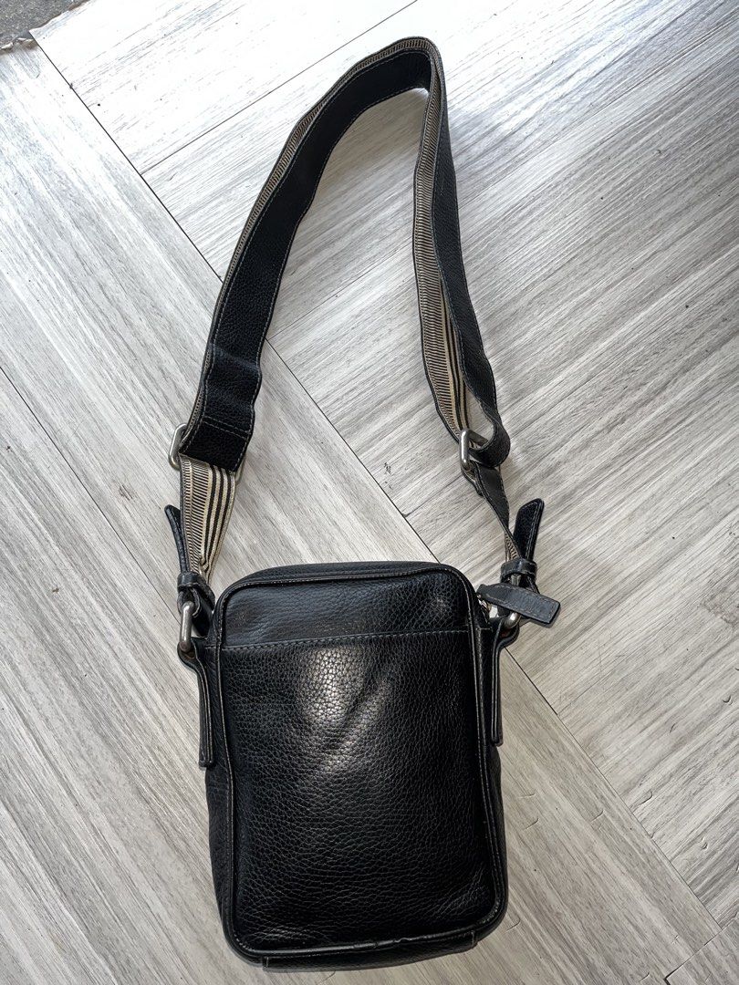 Givenchy Black Leather Crossbody Bag (Category: Luxury Bags & Wallets) located in Manila. Submitted by lux_for_sale (Listing ID 1471063902, Image 2). Description: Black pebbled leather Givenchy messenger bag. Adjustable canvas and leather shoulder strap. Silver-tone hardware throughout. Embossed logo design on the front flap. Zipper closure with debossed leather pull tab. Back slip pocket for easy access. Compact size for daily essentials..