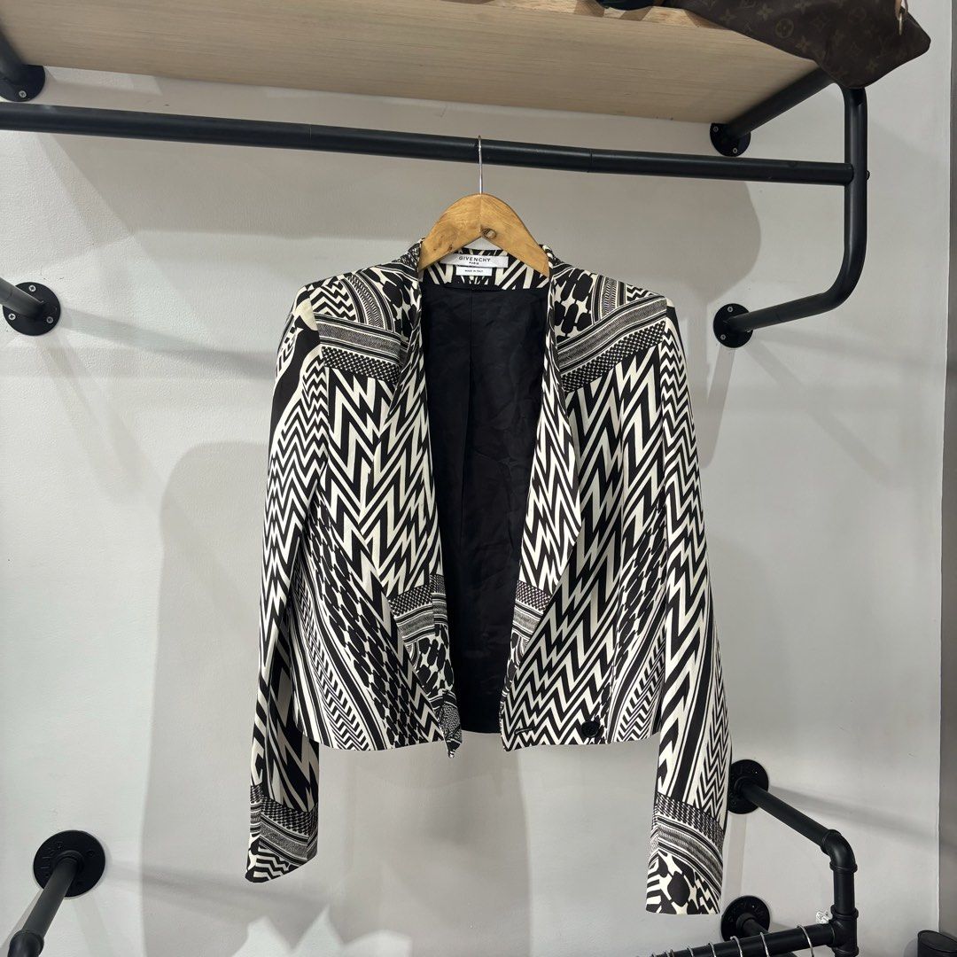 Givenchy Paris Black and White Geometric Pattern Blazer Jacket (Category: Coats, Jackets and Outerwear) located in Bambang. Submitted by heats777 (Listing ID 1471038329, Image 2). Description: - Brand: Givenchy Paris - Design: Striking all-over black and white geometric pattern - Fit: Open front with structured shoulders - Details: Fully lined in solid black - Material: Wool-blend exterior with comfortable cupra lining - Origin: Made in Italy - C
