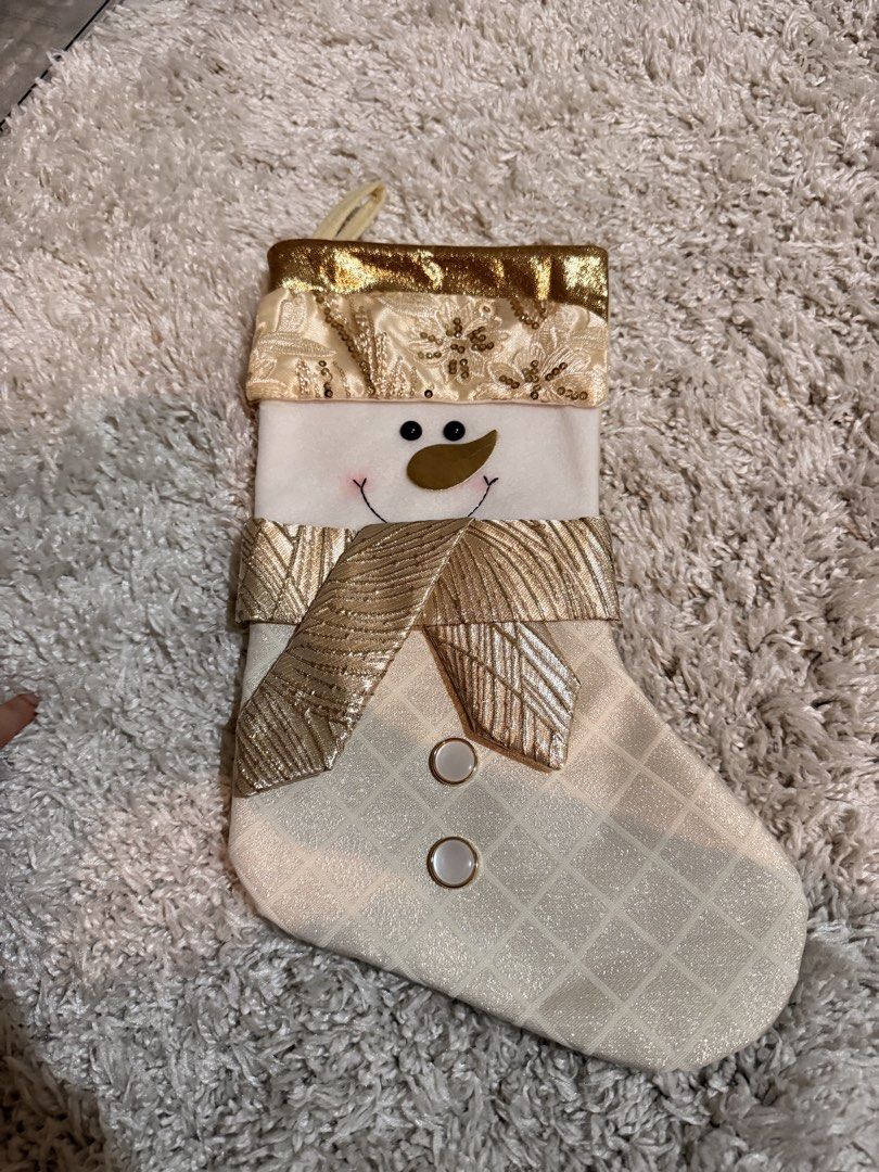 Gold and White Snowman Christmas Stocking (Category: Character Goods) located in Mandaluyong City. Submitted by riz_040521 (Listing ID 1470976019, Image 1). Description: - Festive snowman design with elegant gold and white metallic details - Features a sparkling sequin floral cuff, shimmering gold scarf, and cute button accents - Solid light-colored backing for a clean look -selling for 280.