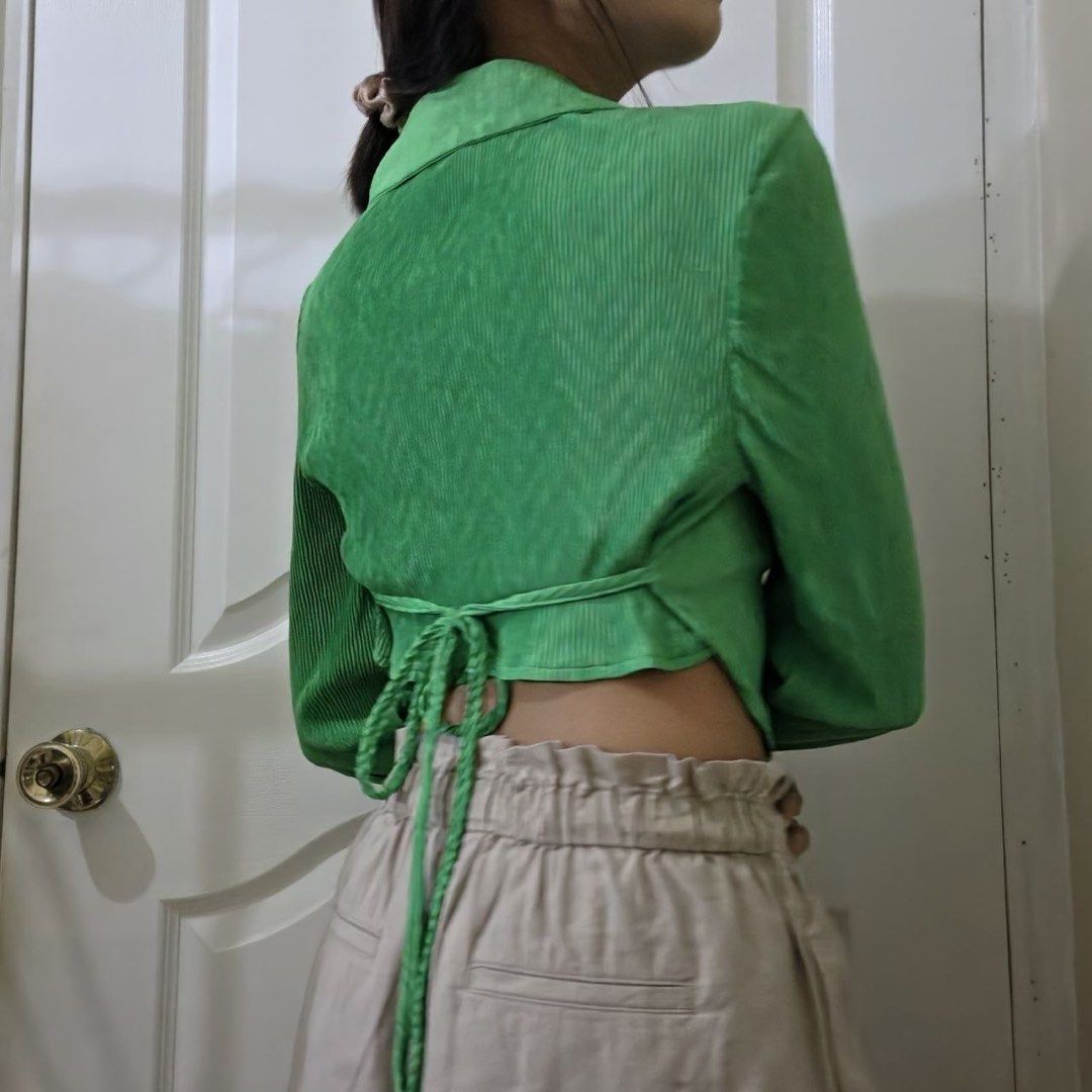 Green button-down crop top with collar and tie back (Category: Blouses) located in Marikina City. Submitted by preloved.mana (Listing ID 1471088013, Image 2). Description: - Emerald green - Textured long-sleeve crop top with wrap-around tie string - MOP: gcash, maya - MOD: jnt, lalamove - LOC: marikina .