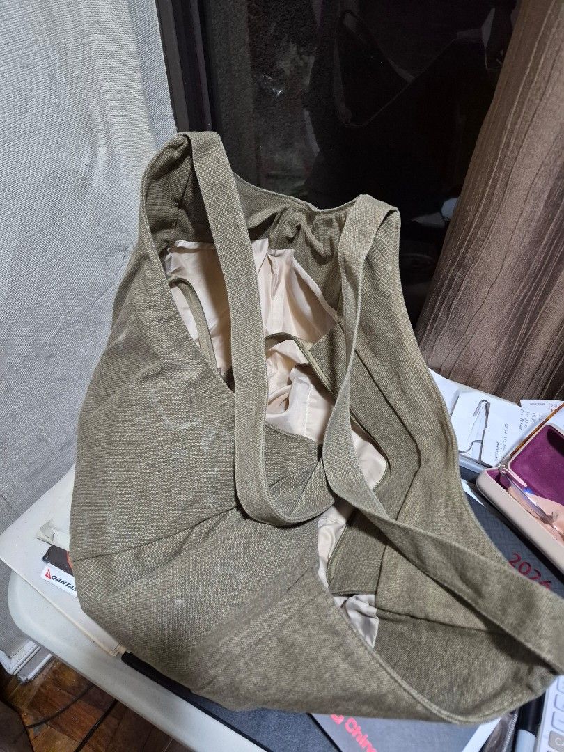 Green Canvas Tote Bag Shoulder Bag (Category: Tote Bags) located in Manila. Submitted by amazingshopper2024 (Listing ID 1471079800, Image 2). Description: - Color: Olive green with cream inner lining - Material: Sturdy canvas with strong shoulder straps - Storage: Big and roomy, easily fits a large water bottle and daily essentials - Features: Convenient zipped inner pocket for secure storage - Style: Casual everyday bag.