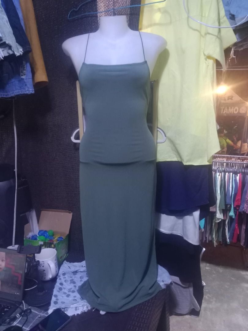 Green Spaghetti Strap Maxi Dress (Category: Dresses) located in Quezon City. Submitted by honeyonline.ph (Listing ID 1471054404, Image 1). Description: - Color: Olive Green - Style: Floor-length maxi dress - Neckline: Straight neckline with thin spaghetti straps - Fit: Form-fitting top with a relaxed long skirt - Design: Plain solid color, simple and versatile for dressing up or down.