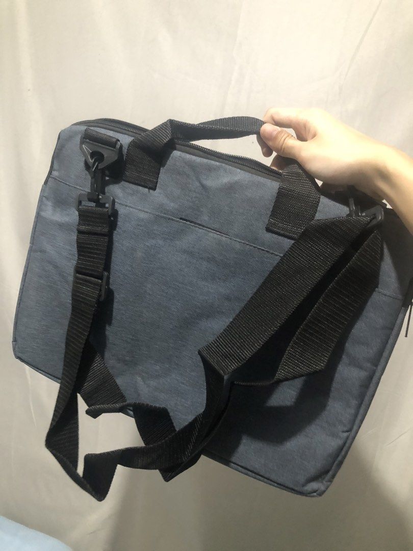 Grey Laptop Bag with Shoulder Strap (Category: Laptop Bags & Sleeves) located in General Trias. Submitted by dmcwl (Listing ID 1471053038, Image 1). Description: PRELOVED LAPTOP BAG FOR SALE! PS: Kasya po dito yung laptop na may numeric keys. RFS: May laptop bag na po akong ginagamit kaya di na din masyado nagagamit. - Color: Grey canvas with black handles - Features: Adjustable shoulder strap, secure top-zip closure, and sturdy side clips - Cond