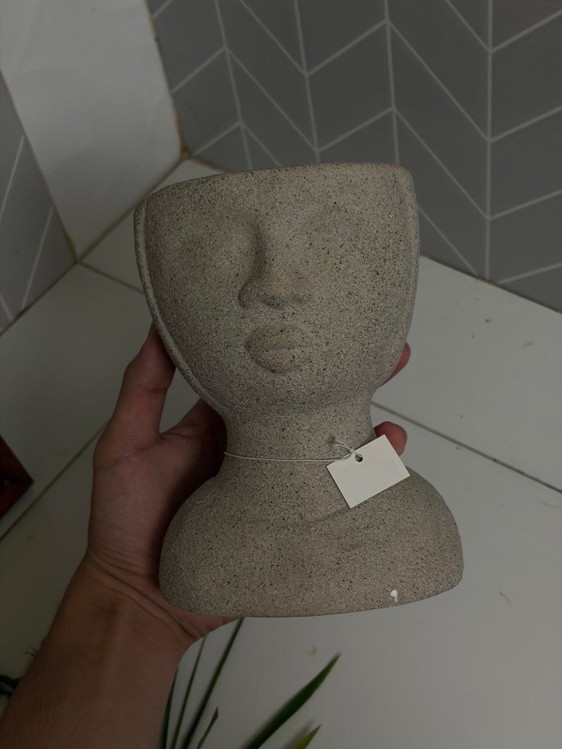 Grey Stone Head Planter Face Vase (Category: Vases & Decorative Bowls) located in Manila. Submitted by arelsnts (Listing ID 1470957325, Image 3). Description: Plant arrangement not included ❗️NEGOTIABLE - Unique grey stone planter shaped like a human head and shoulders - Neutral speckled finish with a smooth ceramic/stone texture - Stands approx. 25 cm tall (verified with ruler in photo) - Hollow top opening perfect for small plants or flower arr