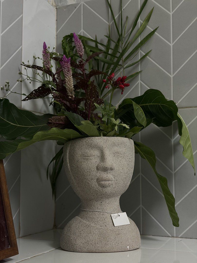 Grey Stone Head Planter Face Vase (Category: Vases & Decorative Bowls) located in Manila. Submitted by arelsnts (Listing ID 1470957325, Image 2). Description: Plant arrangement not included ❗️NEGOTIABLE - Unique grey stone planter shaped like a human head and shoulders - Neutral speckled finish with a smooth ceramic/stone texture - Stands approx. 25 cm tall (verified with ruler in photo) - Hollow top opening perfect for small plants or flower arr
