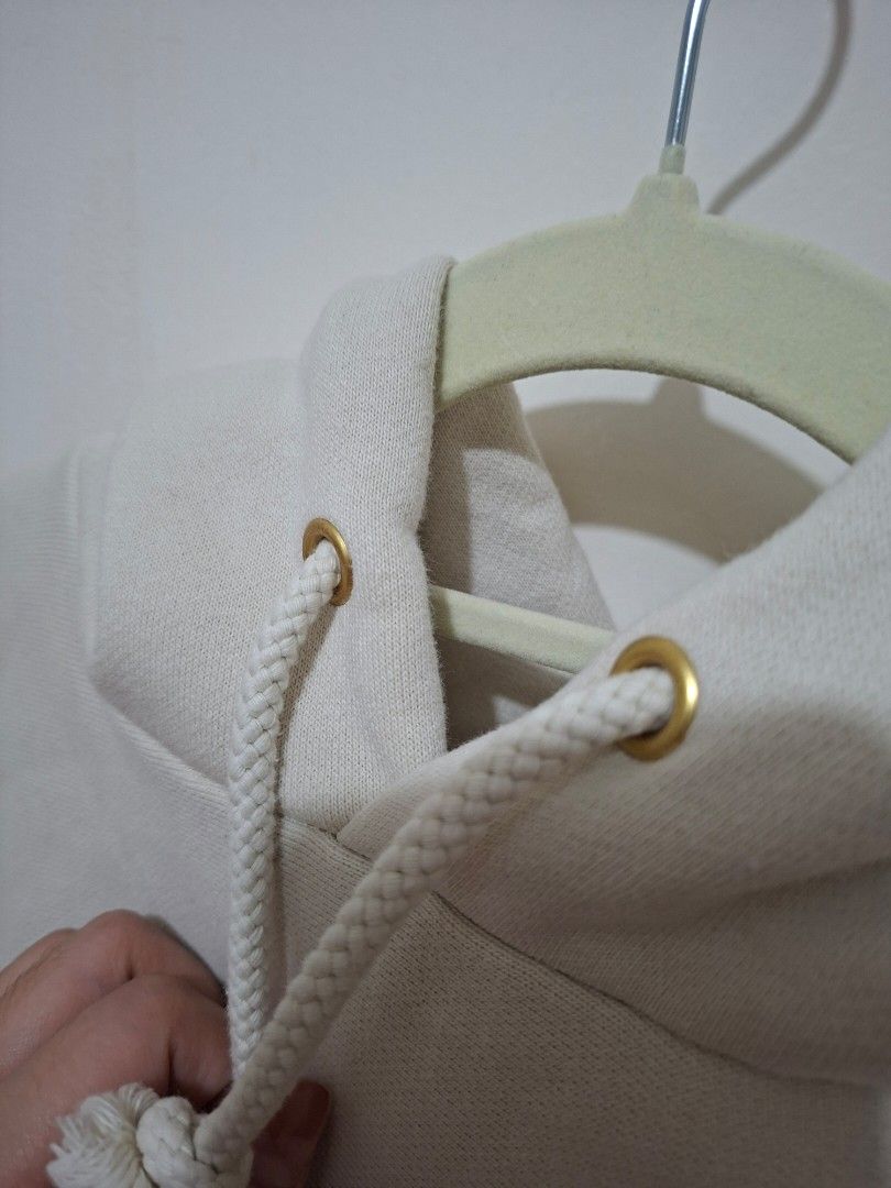 GU Cream beige pullover hoodie with front pocket and drawstrings (Category: Coats, Jackets and Outerwear) located in Paranaque City. Submitted by potatoiceblended (Listing ID 1471049891, Image 3). Description: - Color: Cream beige - Material: Super cozy and thick - Design: Front kangaroo pocket - Details: Thick drawstrings with metal eyelets - Fit: Ribbed cuffs and hem to maintain shape - Style: Solid neutral color that matches everything.