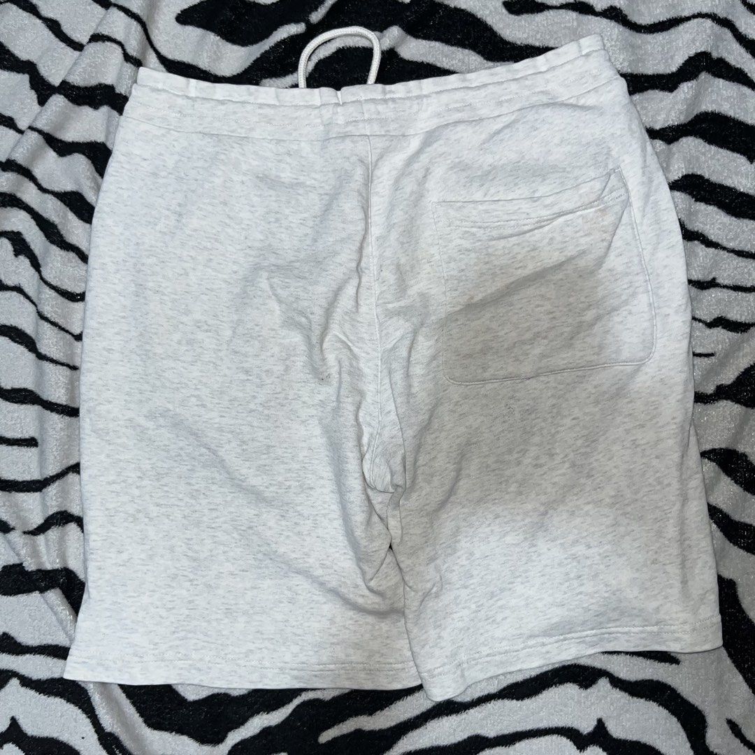 GU Grey Heather Sweatshorts with Drawstring (Category: Shorts) located in Caloocan City. Submitted by thrivo.co (Listing ID 1471029788, Image 2). Description: - Brand: GU - Color: Grey heather - Waistband: Elastic with adjustable white drawstring and metal aglets - Pockets: Two front pockets and one back pocket on the right - Condition: Excellent, fabric care tag intact - Perfect for casual wear and lounging.