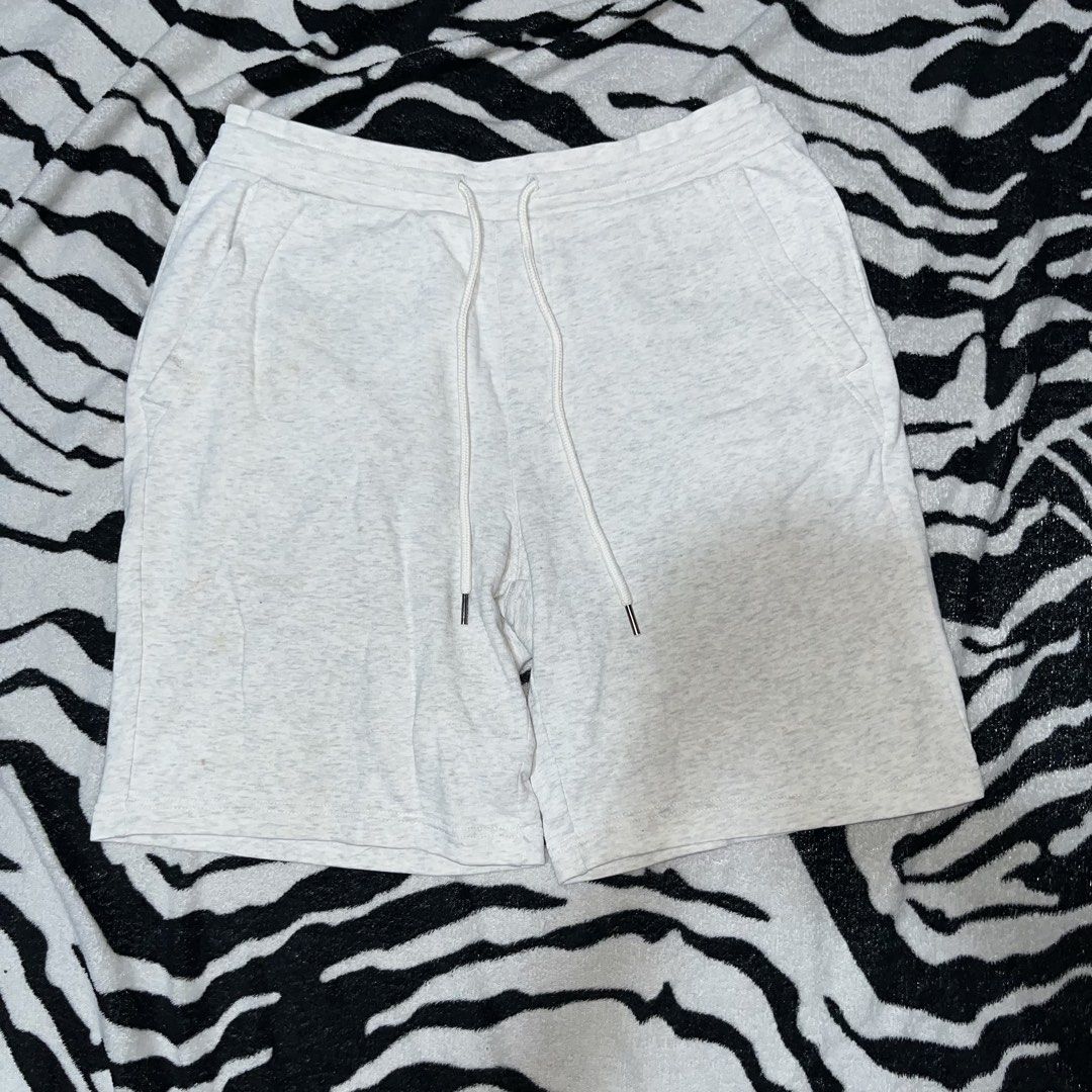 GU Grey Heather Sweatshorts with Drawstring (Category: Shorts) located in Caloocan City. Submitted by thrivo.co (Listing ID 1471029788, Image 1). Description: - Brand: GU - Color: Grey heather - Waistband: Elastic with adjustable white drawstring and metal aglets - Pockets: Two front pockets and one back pocket on the right - Condition: Excellent, fabric care tag intact - Perfect for casual wear and lounging.