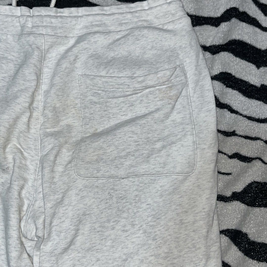 GU Grey Heather Sweatshorts with Drawstring (Category: Shorts) located in Caloocan City. Submitted by thrivo.co (Listing ID 1471029788, Image 3). Description: - Brand: GU - Color: Grey heather - Waistband: Elastic with adjustable white drawstring and metal aglets - Pockets: Two front pockets and one back pocket on the right - Condition: Excellent, fabric care tag intact - Perfect for casual wear and lounging.