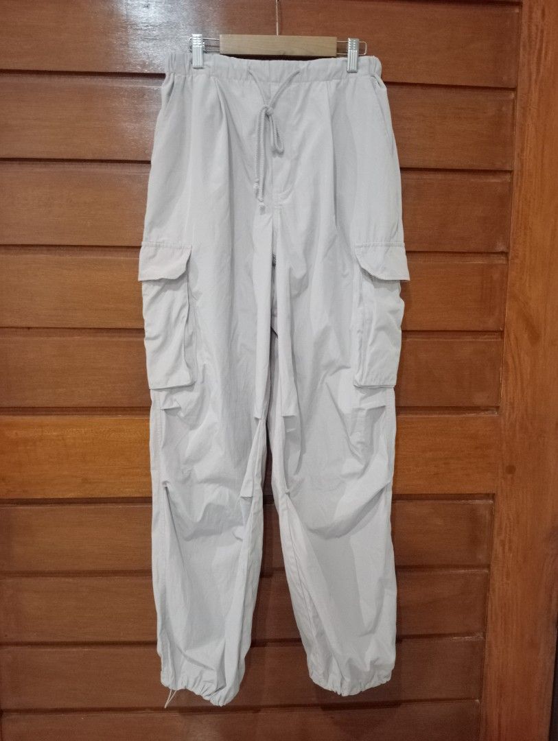 GU Parachute Cargo Pants Light Pink Size M (Category: Jeans) located in Antipolo. Submitted by gigantoshe06492 (Listing ID 1471067728, Image 2). Description: - Brand/Model: GU Parachute Cargo Pants - Color: Pink - Size: M - Material: Cotton and polyester blend - Origin: Made in Indonesia - Fit/Features: Drawstring waist and adjustable ankle cuffs - Storage: Multiple utility pockets on the sides.