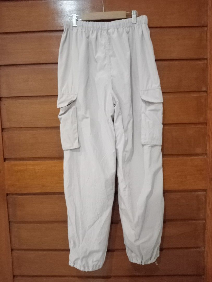 GU Parachute Cargo Pants Light Pink Size M (Category: Jeans) located in Antipolo. Submitted by gigantoshe06492 (Listing ID 1471067728, Image 3). Description: - Brand/Model: GU Parachute Cargo Pants - Color: Pink - Size: M - Material: Cotton and polyester blend - Origin: Made in Indonesia - Fit/Features: Drawstring waist and adjustable ankle cuffs - Storage: Multiple utility pockets on the sides.