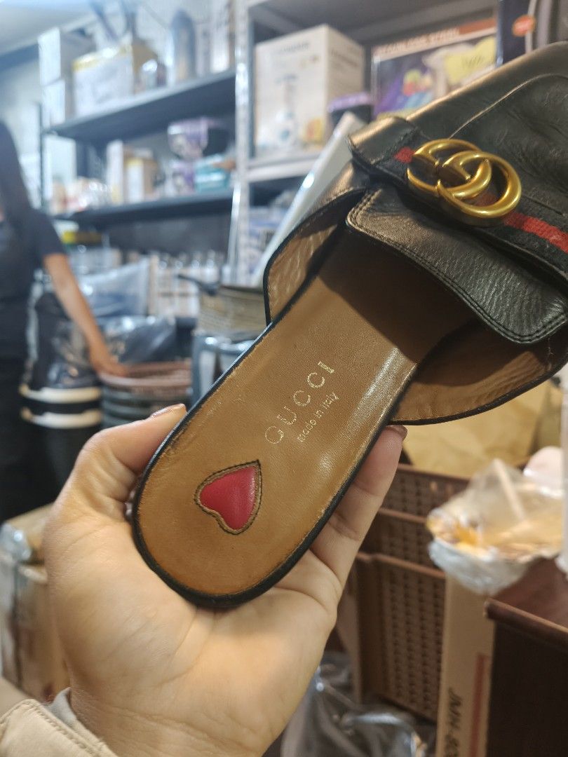 Gucci Black Leather Mules Slides Size 37 (Category: Loafers) located in La Trinidad. Submitted by jinnvendep (Listing ID 1471024722, Image 3). Description: - Brand: Gucci - Style: Slip-on flat mules with a chic square toe - Size: EU 37 - Material: Black leather upper with tan leather lining - Details: Classic red and green web stripe, gold interlocking GG hardware, and a cute pink heart detail near the heel - Condition: Soles show normal wear fro