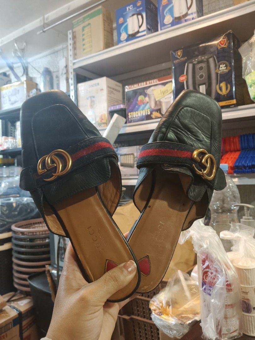 Gucci Black Leather Mules Slides Size 37 (Category: Loafers) located in La Trinidad. Submitted by jinnvendep (Listing ID 1471024722, Image 2). Description: - Brand: Gucci - Style: Slip-on flat mules with a chic square toe - Size: EU 37 - Material: Black leather upper with tan leather lining - Details: Classic red and green web stripe, gold interlocking GG hardware, and a cute pink heart detail near the heel - Condition: Soles show normal wear fro