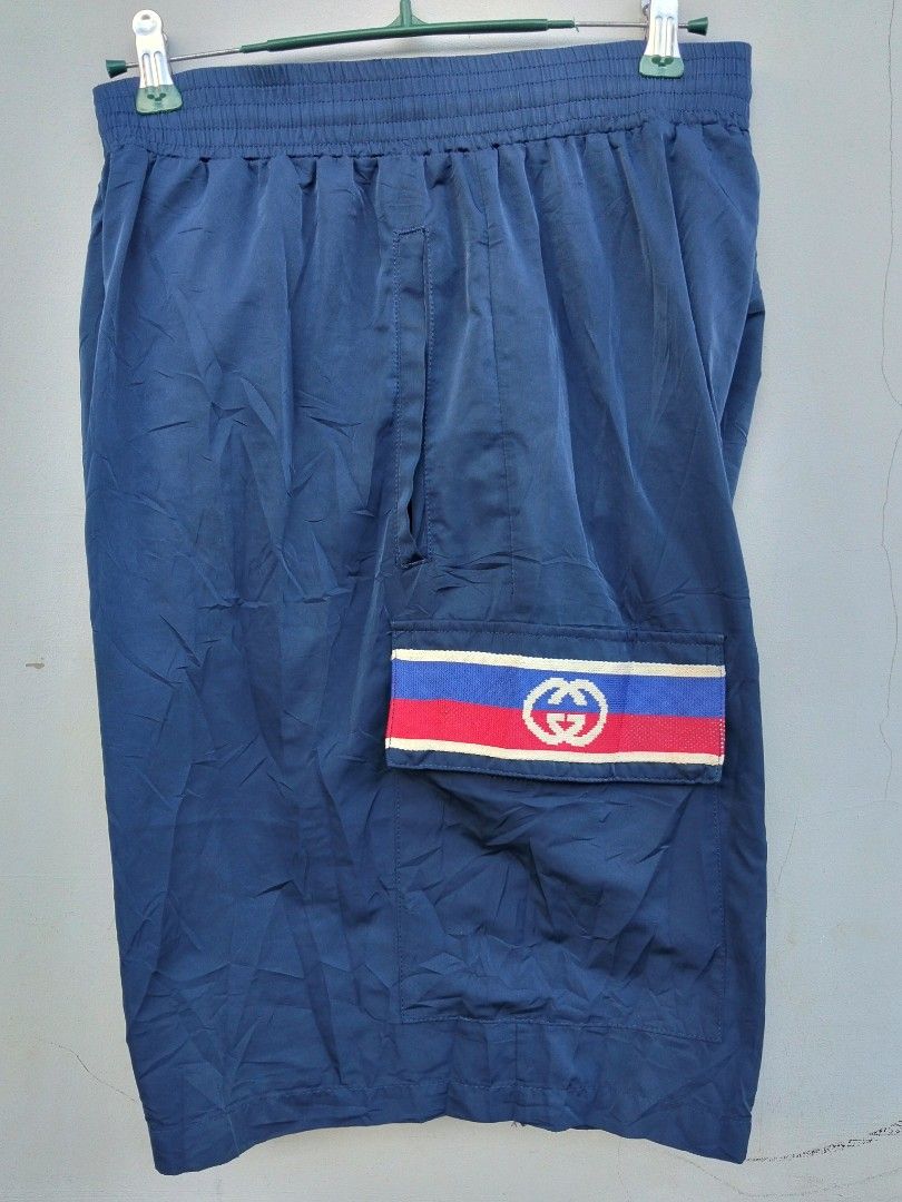 Gucci Blue Cargo Shorts with Interlocking G Logo (Category: Shorts) located in Manila. Submitted by austriakim18807 (Listing ID 1470935369, Image 1). Description: -GUCCI SHORT -Width: 33-36 -Length: 22 -Price :5,000 -Issue: 2pcs small pinhole front - Color: Blue - Style: Casual everyday wear - Waistband: Comfortable elastic - Pockets: Dual side pockets with snap button closure - Accents: Red, white, and blue stripe bands with interlocking G logo 