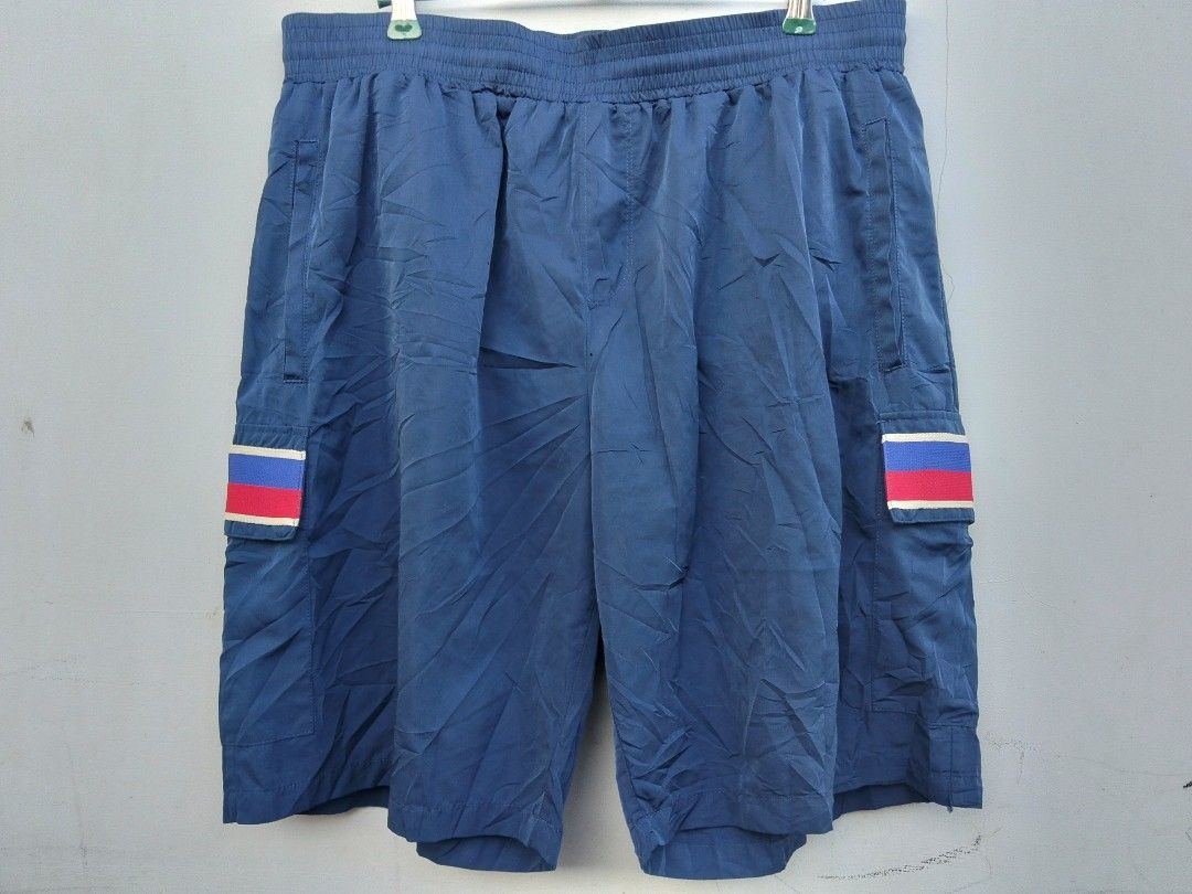 Gucci Blue Cargo Shorts with Interlocking G Logo (Category: Shorts) located in Manila. Submitted by austriakim18807 (Listing ID 1470935369, Image 3). Description: -GUCCI SHORT -Width: 33-36 -Length: 22 -Price :5,000 -Issue: 2pcs small pinhole front - Color: Blue - Style: Casual everyday wear - Waistband: Comfortable elastic - Pockets: Dual side pockets with snap button closure - Accents: Red, white, and blue stripe bands with interlocking G logo 