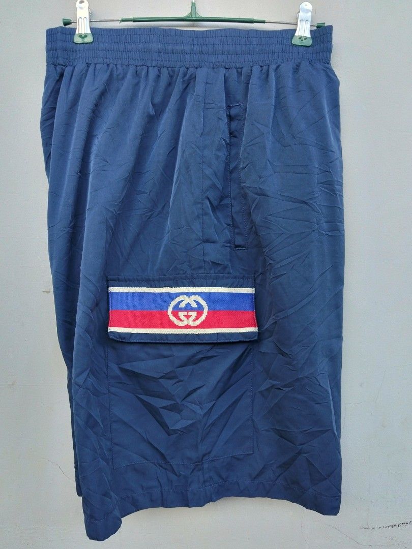 Gucci Blue Cargo Shorts with Interlocking G Logo (Category: Shorts) located in Manila. Submitted by austriakim18807 (Listing ID 1470935369, Image 2). Description: -GUCCI SHORT -Width: 33-36 -Length: 22 -Price :5,000 -Issue: 2pcs small pinhole front - Color: Blue - Style: Casual everyday wear - Waistband: Comfortable elastic - Pockets: Dual side pockets with snap button closure - Accents: Red, white, and blue stripe bands with interlocking G logo 