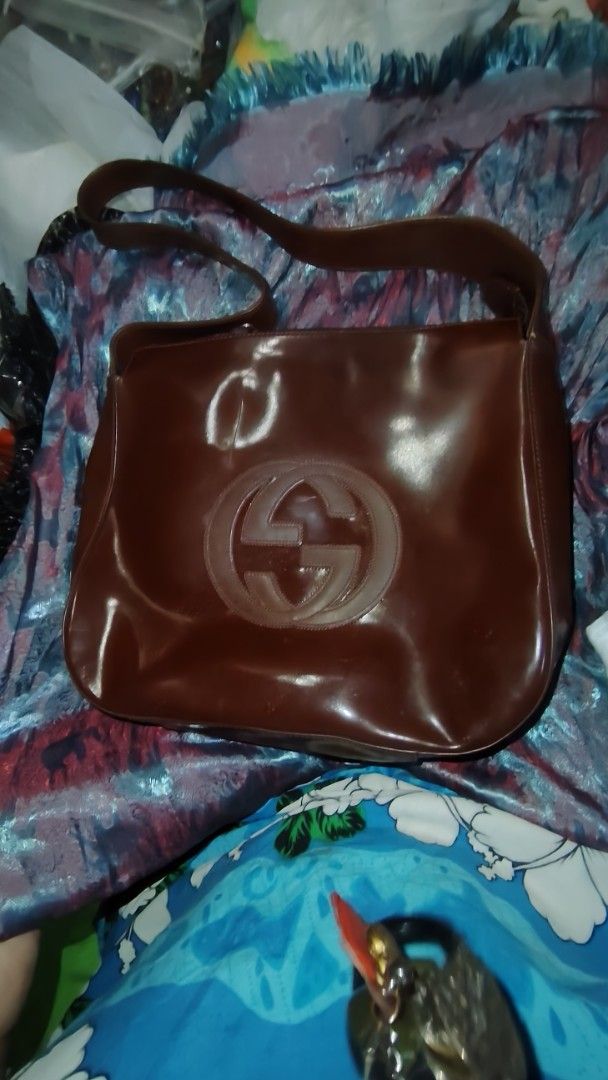 Gucci Brown Leather Shoulder Bag (Category: Luxury Bags & Wallets) located in Manila. Submitted by purediamond888 (Listing ID 1471054677, Image 1). Description: - Brand: Gucci - Material: Rich brown leather with a smooth, glossy finish - Design: Structured shape with a large debossed interlocking G logo on the front - Closure: Secure zipper top closure - Interior: Roomy and clean, ideal for your daily essentials - Strap: Wide and comfortable shou