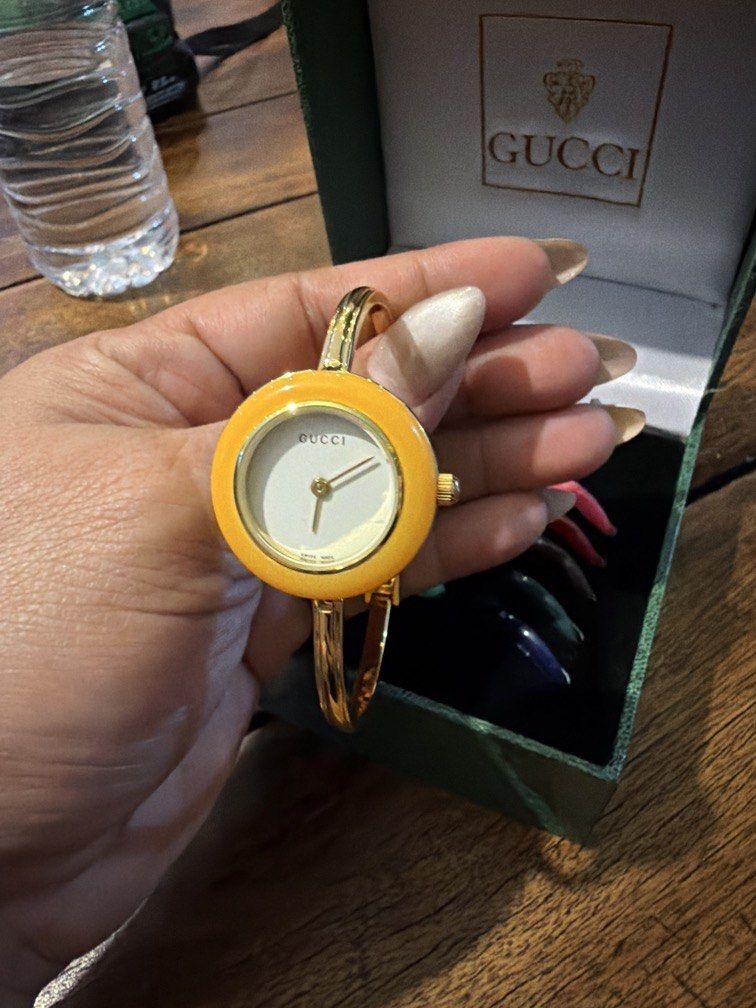 Gucci Change Bezel Bangle Watch with Interchangeable Bezels (Category: Women's Watches) located in Manila. Submitted by shemineforever (Listing ID 1471065126, Image 1). Description: - Authentic vintage Gucci bangle watch - Gold-tone hardware with classic white dial - Includes full set of interchangeable colored bezels (red, blue, green, yellow, and more) - Comes with original green presentation box - Keeps time accurately - New battery included -