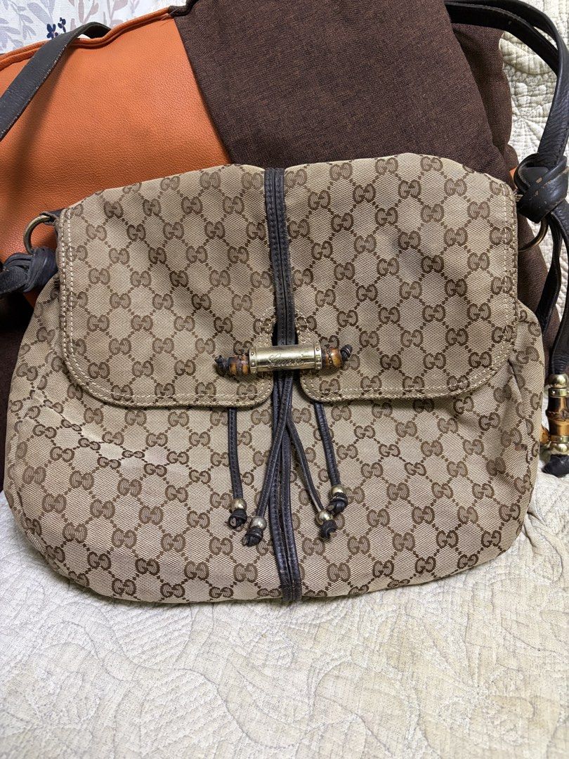 Gucci GG Canvas Bamboo Shoulder Bag (Category: Luxury Bags & Wallets) located in Saravia. Submitted by clynlyn (Listing ID 1471069892, Image 1). Description: - Gucci monogram canvas shoulder bag - Classic brown leather trim with distinctive bamboo and metal toggle hardware - Stylish drawstring details with bamboo accents - Secure magnetic snap button closure under the front flap - Brown fabric-lined interior with an inner zipper pocket - Serial n