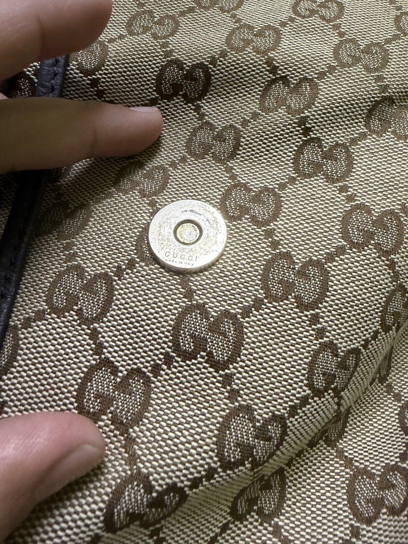 Gucci GG Canvas Bamboo Shoulder Bag (Category: Luxury Bags & Wallets) located in Saravia. Submitted by clynlyn (Listing ID 1471069892, Image 2). Description: - Gucci monogram canvas shoulder bag - Classic brown leather trim with distinctive bamboo and metal toggle hardware - Stylish drawstring details with bamboo accents - Secure magnetic snap button closure under the front flap - Brown fabric-lined interior with an inner zipper pocket - Serial n
