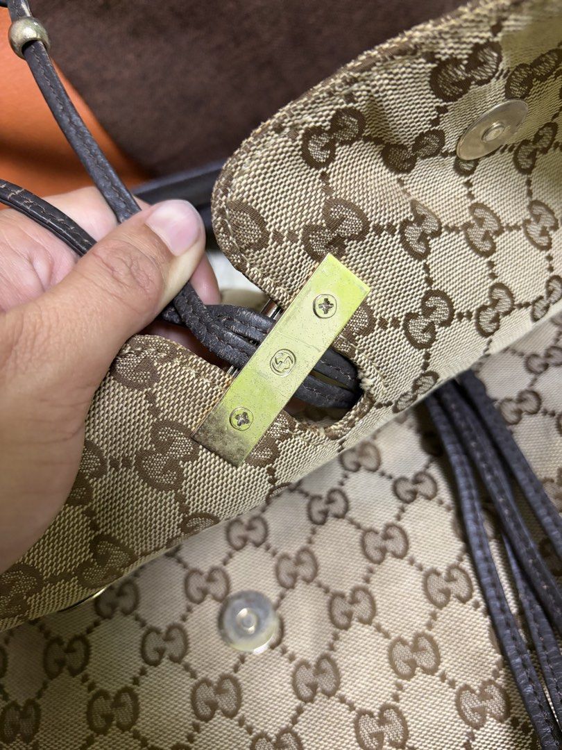 Gucci GG Canvas Bamboo Shoulder Bag (Category: Luxury Bags & Wallets) located in Saravia. Submitted by clynlyn (Listing ID 1471069892, Image 3). Description: - Gucci monogram canvas shoulder bag - Classic brown leather trim with distinctive bamboo and metal toggle hardware - Stylish drawstring details with bamboo accents - Secure magnetic snap button closure under the front flap - Brown fabric-lined interior with an inner zipper pocket - Serial n
