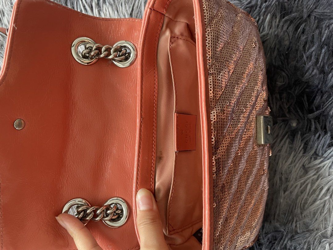 Gucci GG Marmont Sequin Shoulder Bag (Category: Luxury Bags & Wallets) located in Quezon City. Submitted by izxbll_declutters (Listing ID 1470949885, Image 3). Description: - Authentic Gucci GG Marmont shoulder bag - Stunning rose gold sequins with chevron quilting - Vibrant orange leather trim and strap backing - Antique silver-tone hardware and iconic interlocking GG closure - Versatile sliding chain strap (wear single or doubled) - Luxurious p