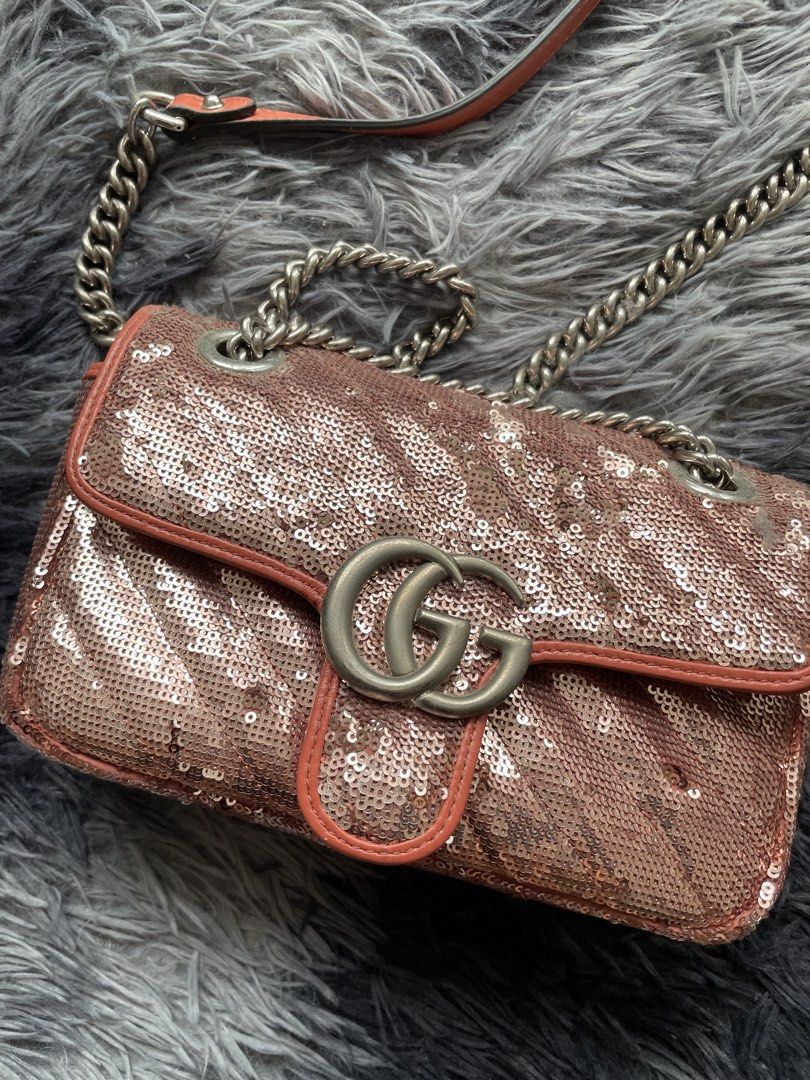 Gucci GG Marmont Sequin Shoulder Bag (Category: Luxury Bags & Wallets) located in Quezon City. Submitted by izxbll_declutters (Listing ID 1470949885, Image 2). Description: - Authentic Gucci GG Marmont shoulder bag - Stunning rose gold sequins with chevron quilting - Vibrant orange leather trim and strap backing - Antique silver-tone hardware and iconic interlocking GG closure - Versatile sliding chain strap (wear single or doubled) - Luxurious p