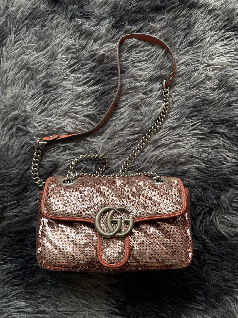 Gucci GG Marmont Sequin Shoulder Bag (Category: Luxury Bags & Wallets) located in Quezon City. Submitted by izxbll_declutters (Listing ID 1470949885, Image 1). Description: - Authentic Gucci GG Marmont shoulder bag - Stunning rose gold sequins with chevron quilting - Vibrant orange leather trim and strap backing - Antique silver-tone hardware and iconic interlocking GG closure - Versatile sliding chain strap (wear single or doubled) - Luxurious p