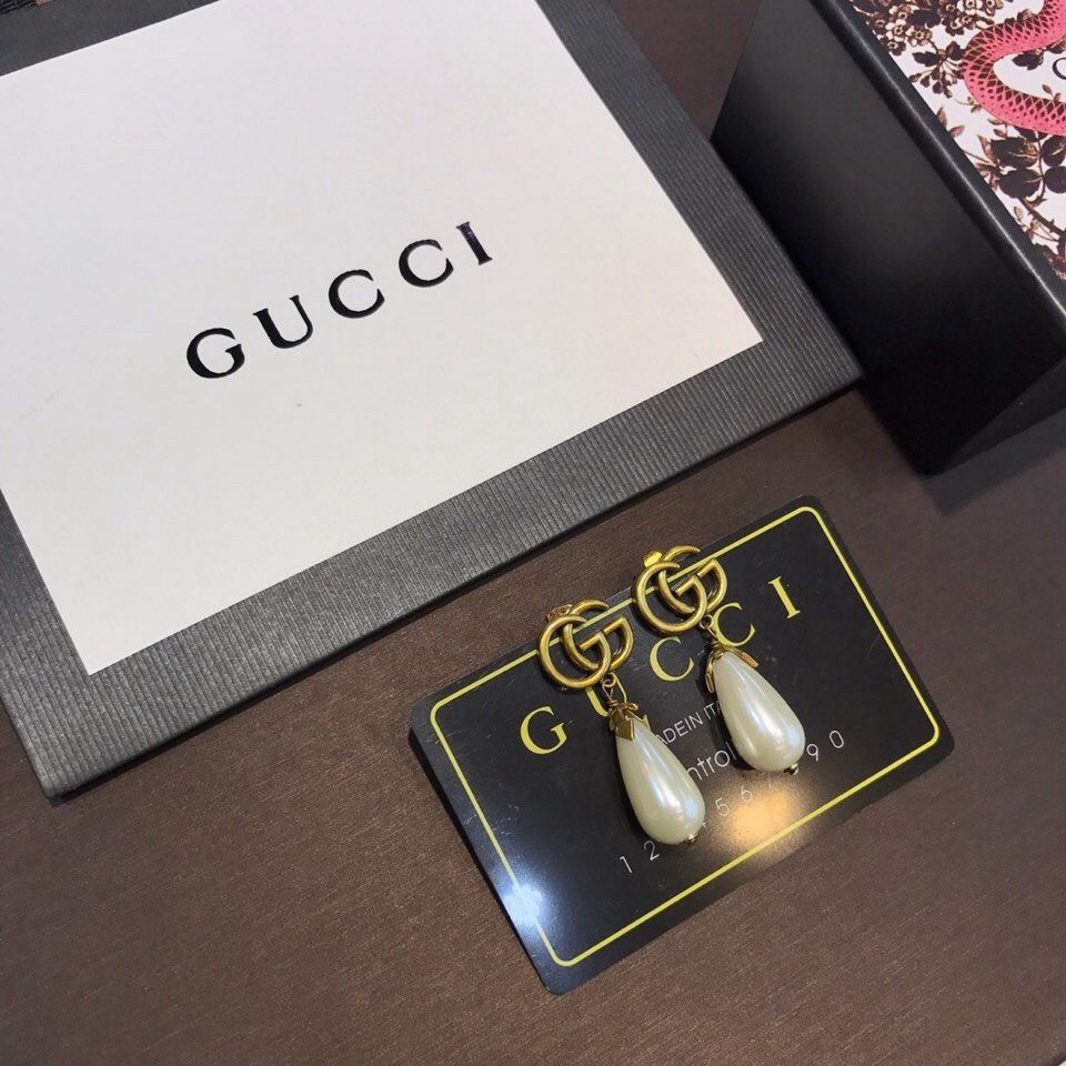 Gucci outlet Double G Pearl Drop Earrings (Category: Earrings) located in Caloocan City. Submitted by nobleshark-d53c7a (Listing ID 1471068848, Image 3). Description: - Authentic outlet Gucci drop earrings - Iconic GG logo in an elegant aged gold tone - Dangling white teardrop pearls attached underneath - Secure post-back closure - Includes original Gucci box, paper bag, and controllato card.