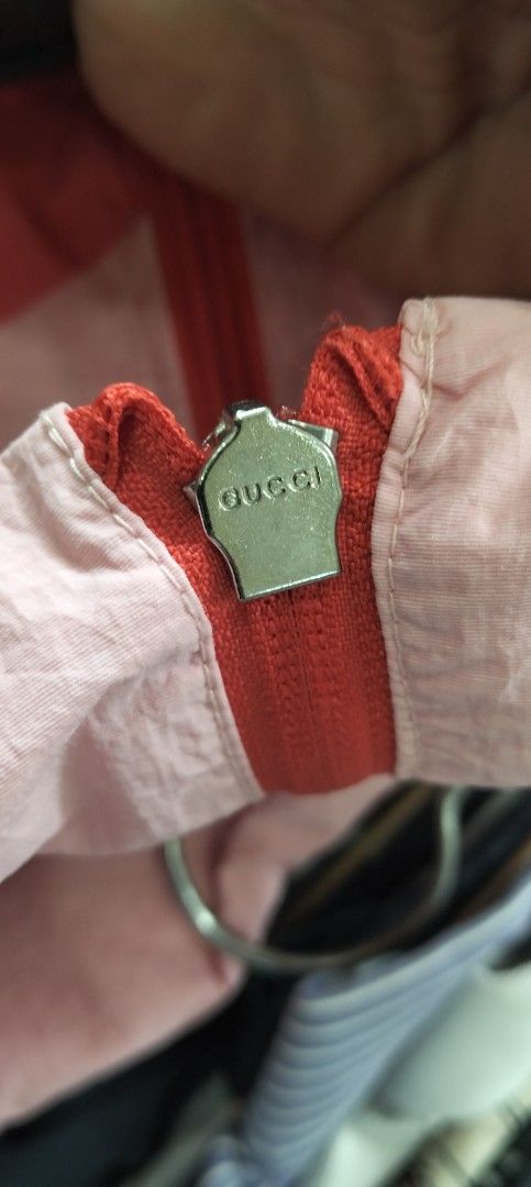 Gucci Pink Windbreaker Jacket with Interlocking G Logo (Category: Coats, Jackets and Outerwear) located in Bacolod City. Submitted by hurleydediamante0513 (Listing ID 1471014859, Image 2). Description: - Brand: Gucci - Style: Zip-up lightweight nylon windbreaker - Color: Pink with iconic red oversized G logo - Accents: Green and red web stripe detailing down both sleeves - Features: Red ribbed cuffs and hem, full front zipper with Gucci branded m
