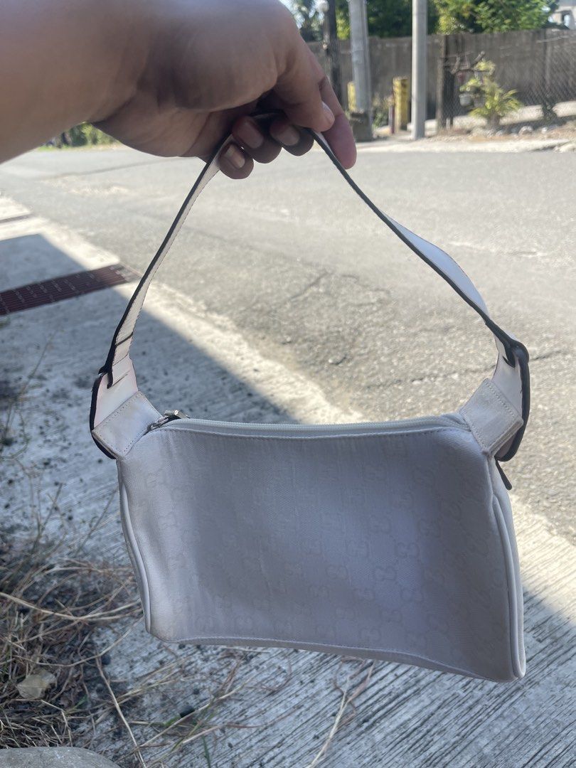 Gucci White Monogram Shoulder Bag with Pink Charm (Category: Luxury Bags & Wallets) located in Bauang. Submitted by Fuzakenn (Listing ID 1471051943, Image 2). Description: - Authentic Gucci shoulder bag in classic monogram canvas - Convenient top zipper closure with a comfortable single strap - Comes with a signature pink leather charm tag (Gucci made in Italy) - Condition: Visible wear and minor discoloration on the fabric, strap corners, and ta
