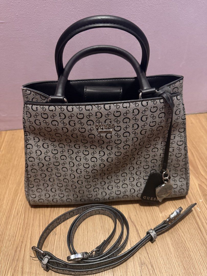 Guess Monogram Tote Bag with Crossbody Strap (Category: Luxury Bags & Wallets) located in Pasig City. Submitted by sea321 (Listing ID 1470941967, Image 1). Description: Guess tote bag in grey and black monogram print. Dual top handles plus a long detachable crossbody strap. Includes branded hanging charms and keyring tag. Magnetic snap closure on the main compartment, plus an interior zipped pocket and slip pockets. Fabric lining with Guess logo 