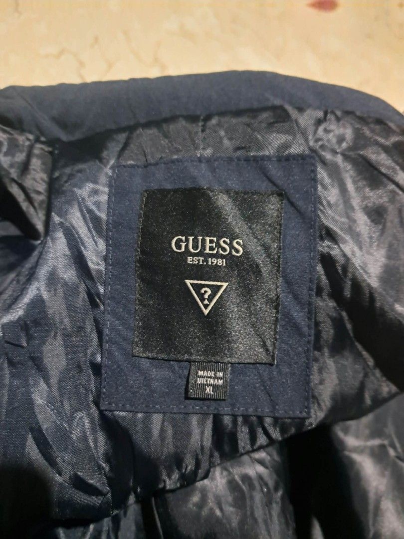 Guess Navy Long Coat Jacket Waterproof Size XL (Category: Coats, Jackets and Outerwear) located in Manila. Submitted by alexson10 (Listing ID 1471069018, Image 3). Description: - Brand: Guess - Style: Long coat / jacket - Color: Solid dark blue (navy) - Size: XL - Measurements: Width 23" | Length 34" - Material: Waterproof (great for rainy days) - Origin: Made in Vietnam - Closure: Front button and zipper - Features: Includes inner lining with a 