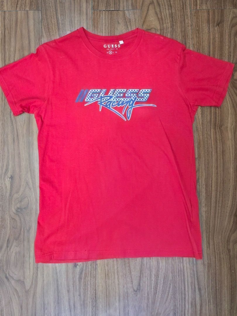 Guess Racing Red T-Shirt (Category: Tshirts & Polo Shirts ) located in Manila. Submitted by zmpnsln (Listing ID 1471075825, Image 1). Description: GUESS Racing Red Graphic T-Shirt – Men's M Asking Price: ₱399 (Negotiable) - Brand: GUESS Los Angeles - Size: Men's Medium (M) - Color: Red with Blue, White, and Black Graphics - Style: Graphic Casual T-Shirt - Neckline: Crewneck - Sleeves: Short Sleeves - Design: GUESS Racing Motorsport-Inspired Graph