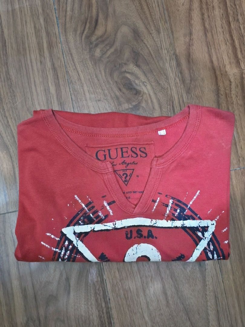 Guess Red V-Neck Graphic T-Shirt (Category: Shirts) located in Manila. Submitted by zmpnsln (Listing ID 1471076151, Image 2). Description: GUESS Los Angeles Faded Red Triangle Graphic T-Shirt Asking Price: ₱299 (Negotiable) - Brand: GUESS Los Angeles - Size: To be confirmed - Color: Faded Red - Style: Graphic Casual T-Shirt - Neckline: Notched Crewneck - Sleeves: Short Sleeves - Design: Large GUESS Triangle Logo Graphic - Print: White and Black D