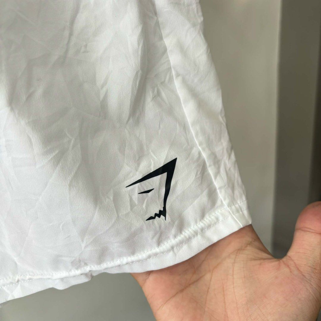Gymshark White Training Shorts Size L (Category: Shorts) located in Bambang. Submitted by heats777 (Listing ID 1471010961, Image 3). Description: - Brand: Gymshark - Item: Men's Training Shorts - Color: Crisp White - Size: L - Material: 100% Lightweight Polyester - Features: Elastic waistband with drawstring, iconic printed logo near hem - Condition: Great for workouts or casual wear, easy to wash - Mode of Payment: GCash, Bank Transfer - Shippin