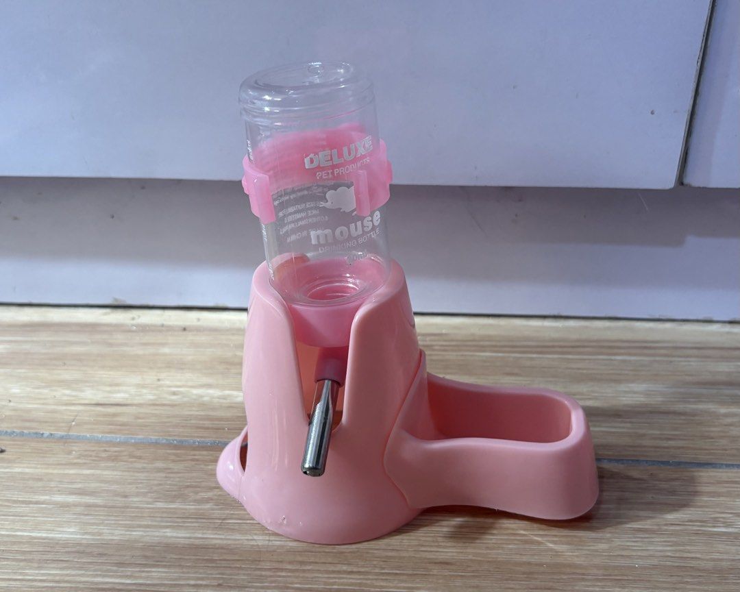 Hamster cage accessories bundle house wheel water bottle (Category: Homes & Other Pet Accessories) located in Quezon City. Submitted by kyjnll (Listing ID 1470987940, Image 2). Description: - Bundle of 4 essential hamster accessories - Blue & white wooden hideout house with climbing ramp - Pink silent running wheel for quiet nighttime exercise - Pink water bottle with integrated food dish base - Clear plastic cat-eared container for sand bath - C