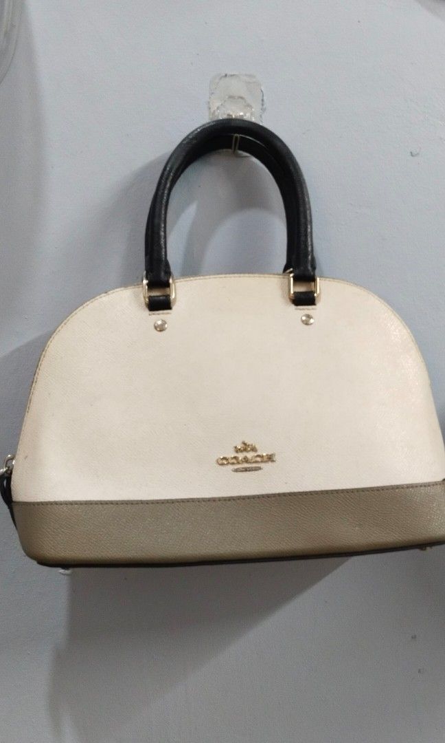 Hand / sling bag (Category: Cross-body Bags) located in Trece Martires City. Submitted by vherma (Listing ID 1470964964, Image 2). Description: two-tone domed satchel bag from Coach, resembling the Coach Mini Sierra Satchel or Cora Dome Satchel in a cream/white and grey-brown colorblock design with black top handles. ykk zip.