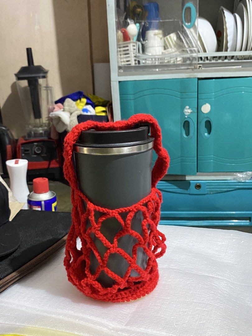 Handmade Crochet Apple Cup Holder/Pouch (Category: Handmade Craft) located in Caloocan City. Submitted by altheadzg (Listing ID 1470964101, Image 3). Description: - Handmade red crochet cup holder with an adorable apple design at the base - Stretchy mesh net style securely fits standard tumblers and water bottles - Comes with a medium strap for convenient hands-free carrying - Cute and practical everyday accessory for coffee runs, walks, and erra