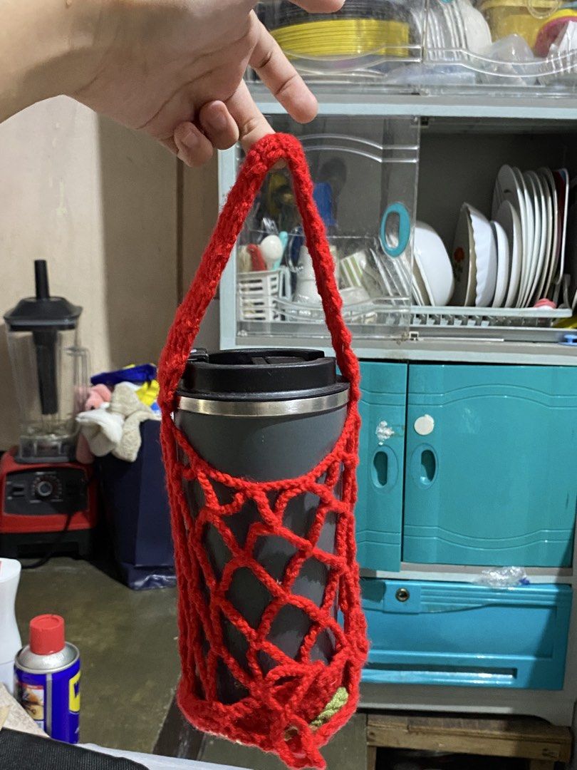 Handmade Crochet Apple Cup Holder/Pouch (Category: Handmade Craft) located in Caloocan City. Submitted by altheadzg (Listing ID 1470964101, Image 2). Description: - Handmade red crochet cup holder with an adorable apple design at the base - Stretchy mesh net style securely fits standard tumblers and water bottles - Comes with a medium strap for convenient hands-free carrying - Cute and practical everyday accessory for coffee runs, walks, and erra