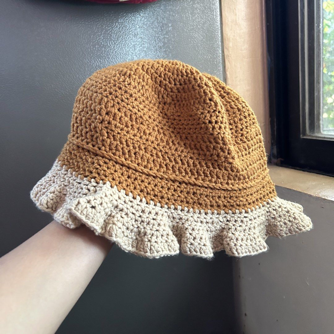 Handmade Crocheted Two-Tone Bucket Hat (Category: Hats & Beanies) located in Manila. Submitted by tasha_11 (Listing ID 1471058783, Image 1). Description: - Handmade crochet bucket hat - Stylish two-tone brown and beige design with a wavy ruffled brim - Soft, lightweight yarn material for all-day comfort - Ideal for everyday outdoor wear - Standard adult size that fits most head shapes easily.