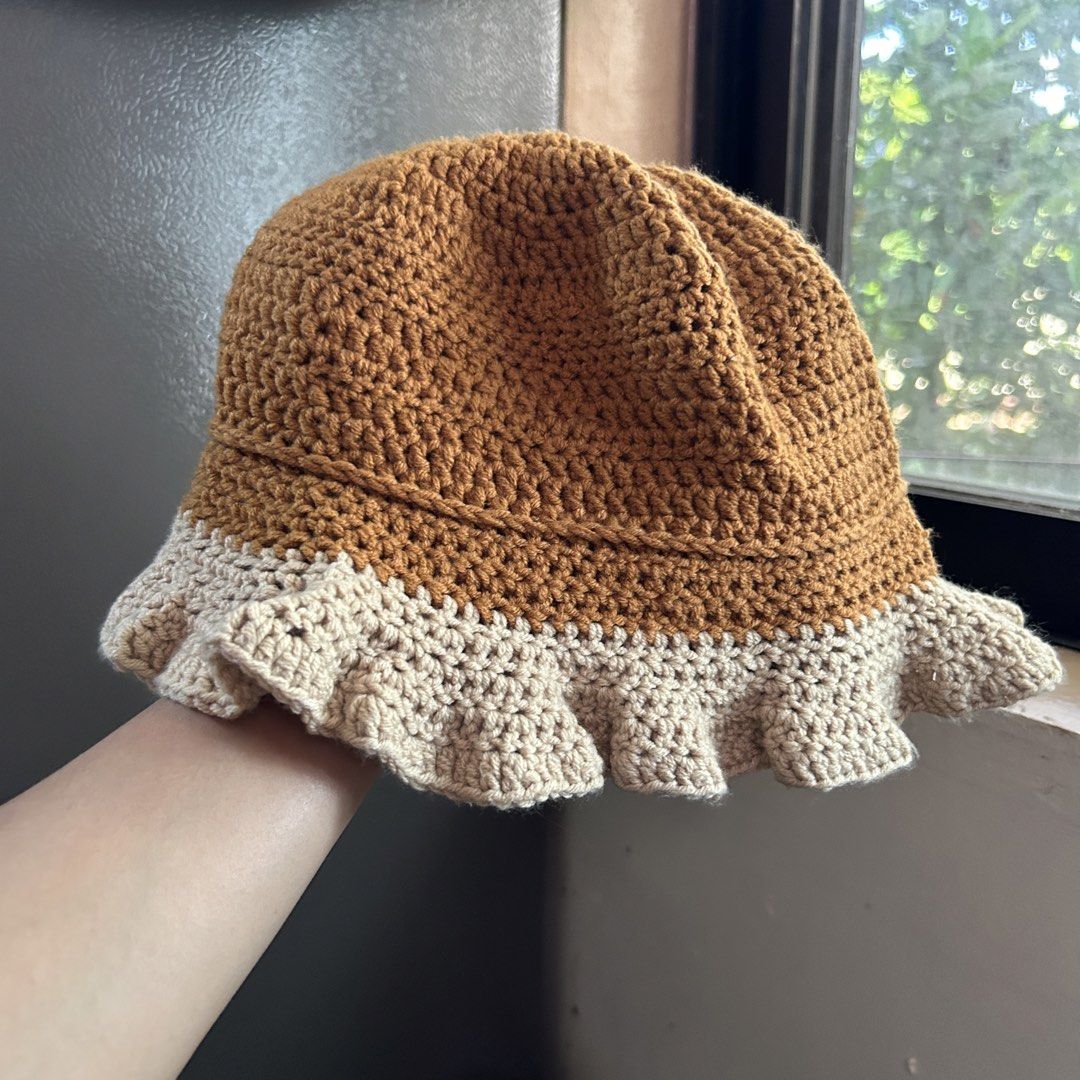 Handmade Crocheted Two-Tone Bucket Hat (Category: Hats & Beanies) located in Manila. Submitted by tasha_11 (Listing ID 1471058783, Image 2). Description: - Handmade crochet bucket hat - Stylish two-tone brown and beige design with a wavy ruffled brim - Soft, lightweight yarn material for all-day comfort - Ideal for everyday outdoor wear - Standard adult size that fits most head shapes easily.
