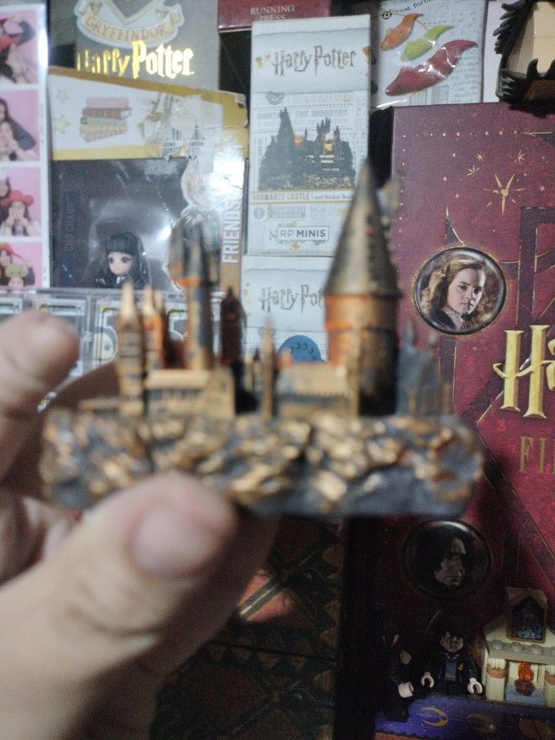 Harry Potter Hogwarts Castle Mini Figurine with Light (Category: Figurines & Statues) located in Paranaque City. Submitted by chechein_shop (Listing ID 1470967334, Image 3). Description: - Official-style miniature Hogwarts castle replica from Harry Potter - Features built-in glowing lights inside the towers for a magical effect - Detailed textured rocky base for realistic display - Compact size, ideal for desk or shelf decoration - Perfect collec